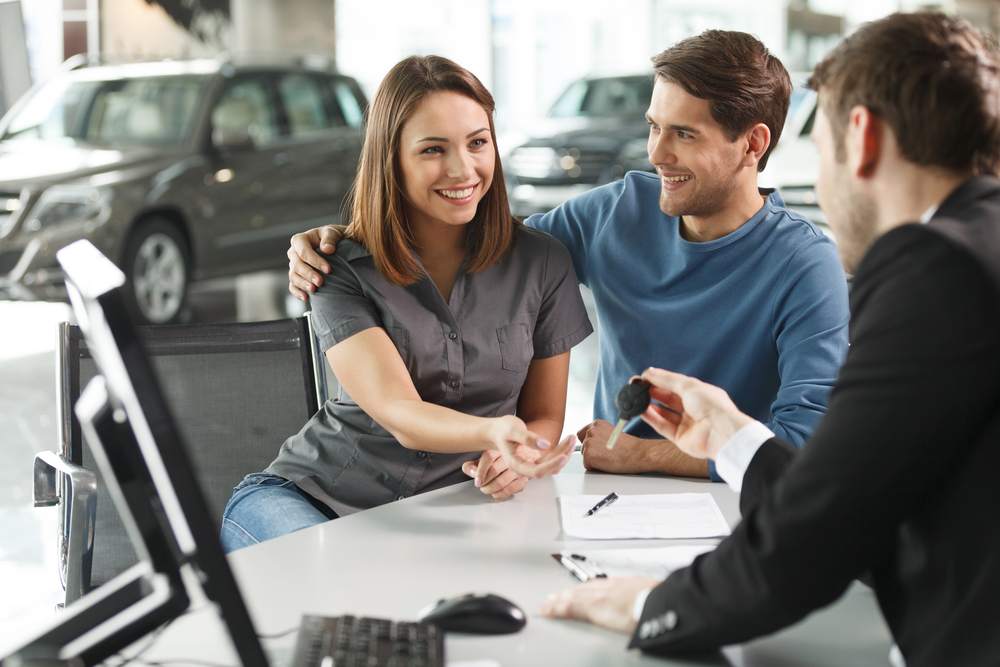 car dealer and consumer in showroom